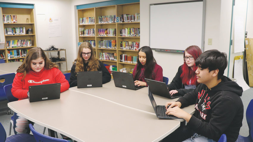 Arvada K-8 students work on school-issued laptops, known as 1:1 devices. The district will distribute 1:1 devices to all students grades five through 12 by 2023. From left to right: Amanda Donald, Bailey Bleskin, Jalissa Ganboa, Carleigh Bentley, Nicolas Sanchez.